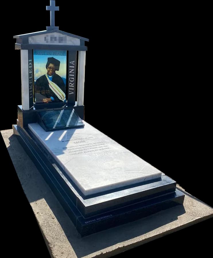 Custom granite memorial with white pillars, a cross and a glass portrait
