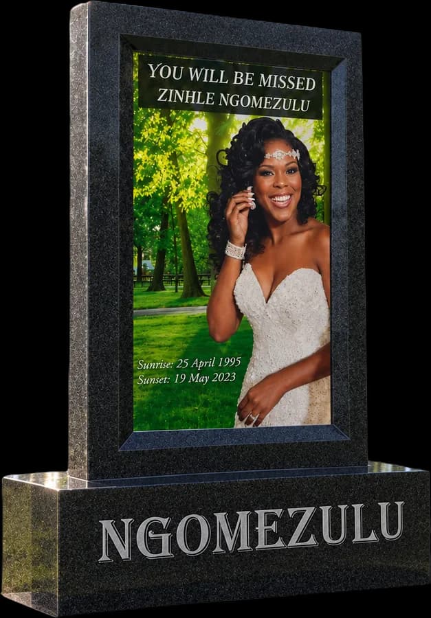 Black granite frame around a glass panel with a photo and words